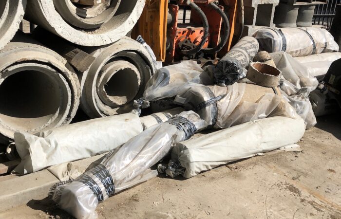 Improper disposal of asbestos pipe, we moved in and with help of remediation company secured and cleaned the area disposing of pipe in legal landfill ,
